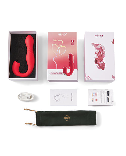 Red sex toy with packaging and accessories on a white background