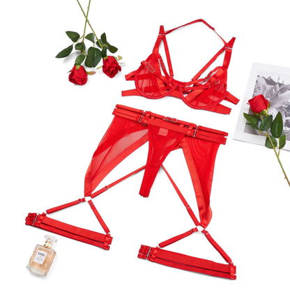 Red lingerie set with roses and a bottle of perfume on a white background