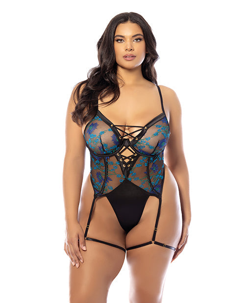 Woman wearing a black and blue lace lingerie set on a white background