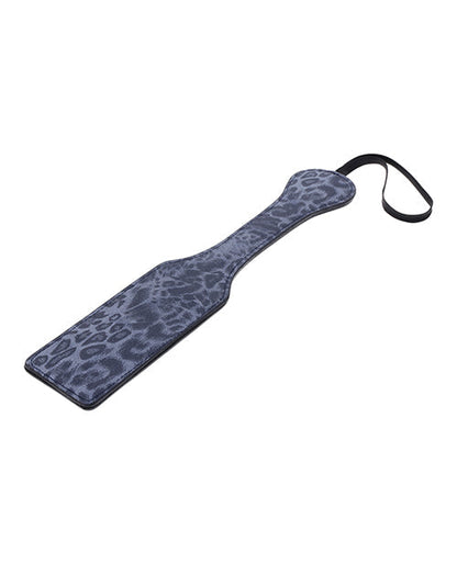 Leopard print paddle with a black strap on a white background