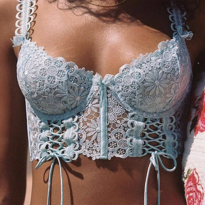 Light blue lace bralette worn by a person with a blurred background