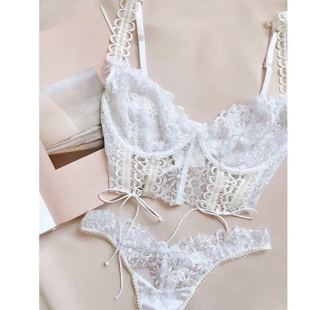 White lace bra and panties set on a beige background