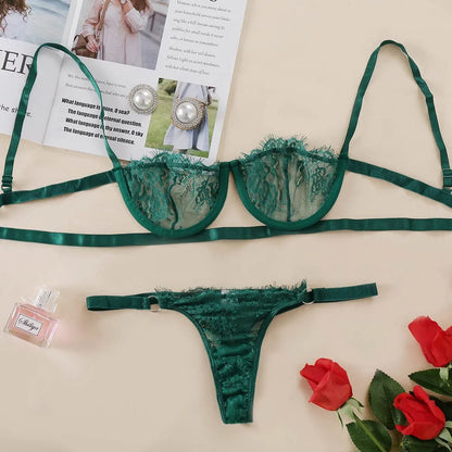 Green lace lingerie set with earrings and perfume on a magazine background