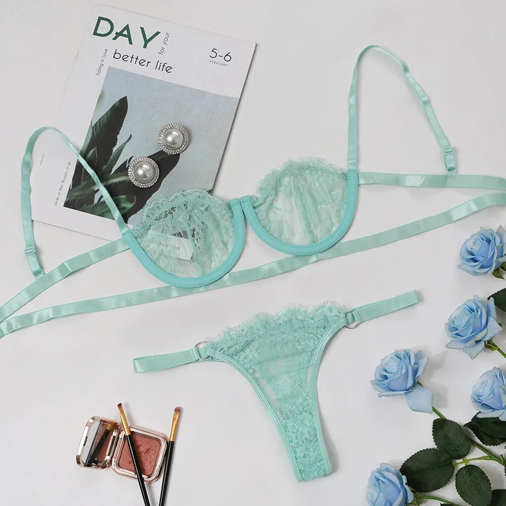 Mint green lace lingerie set with accessories on a white background