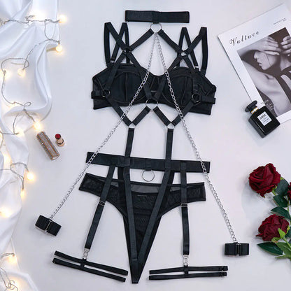 Black lingerie set with chains on a white surface with decorative elements.
