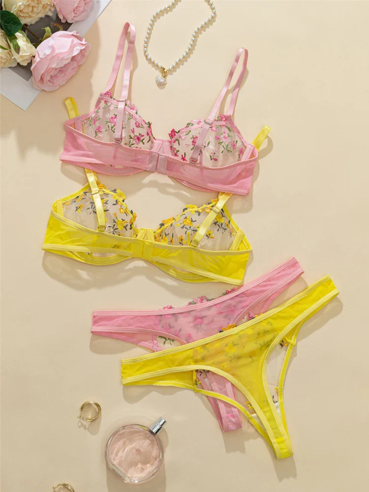 Floral bra and yellow panties on a beige background with flowers and jewelry.