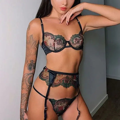 Woman wearing a black lace lingerie set against a neutral background