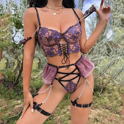 Person wearing a detailed lingerie set with chains in a natural setting