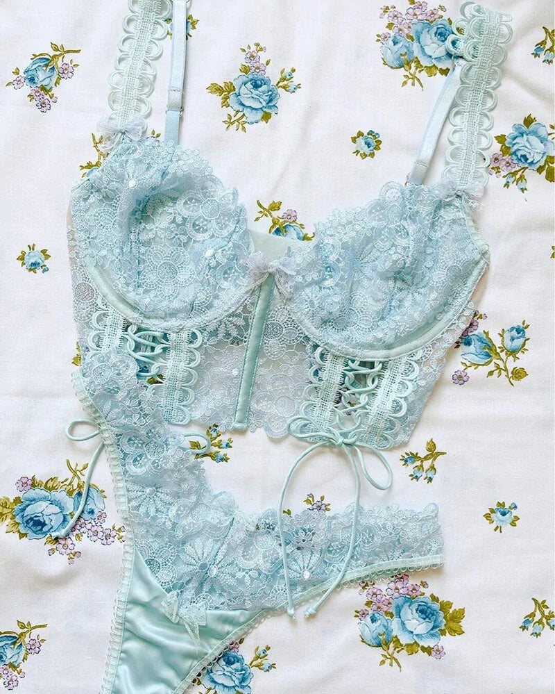 Light blue lace lingerie set on a floral-patterned background