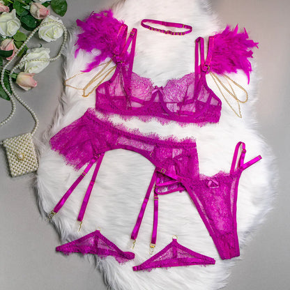 Purple lace lingerie set with accessories on a white surface with flowers and a handbag.