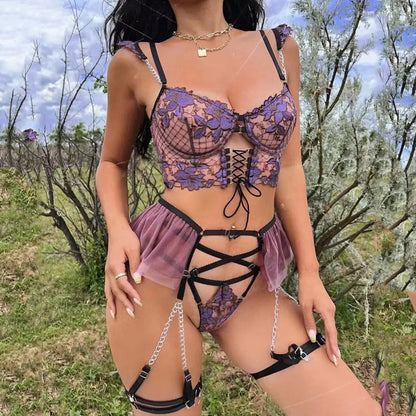 Person wearing a detailed lingerie set with floral patterns outdoors.