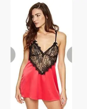 Woman wearing a pink satin nightgown with black lace details on a white background