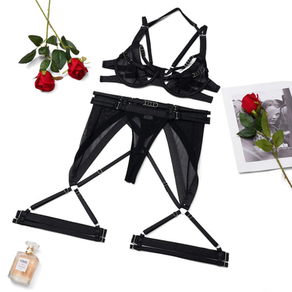 Black lingerie set with roses and a perfume bottle on a white background